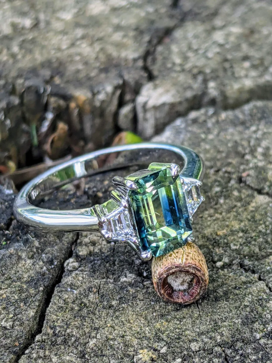 Teal emerald-cut three-stone sapphire engagement ring